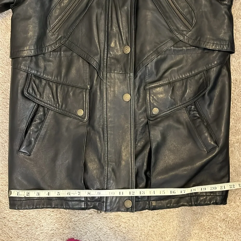Vintage men’s SZ sm black leather coat w/fur trim hood.  Hits below the hips.